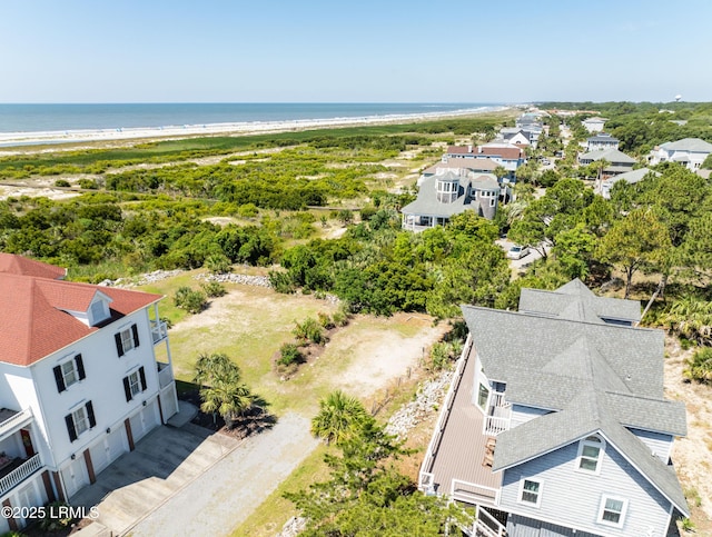 drone / aerial view with a water view and a beach view