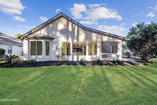 rear view of house with a yard