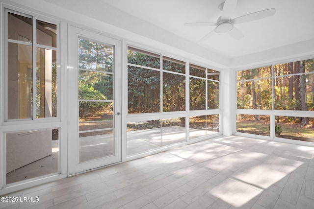 unfurnished sunroom featuring ceiling fan