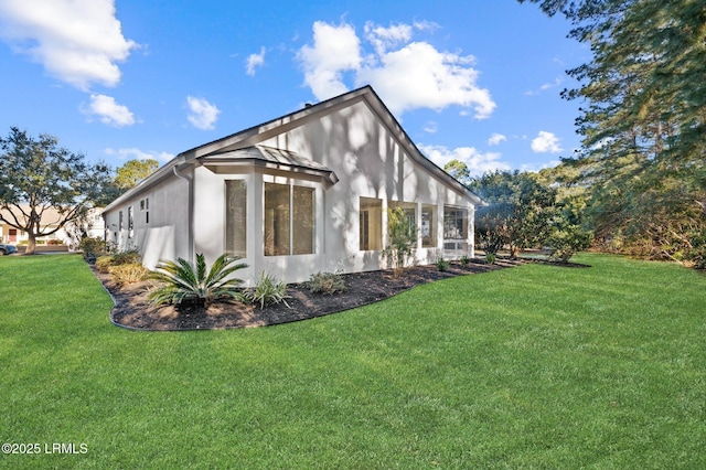 view of side of home featuring a yard