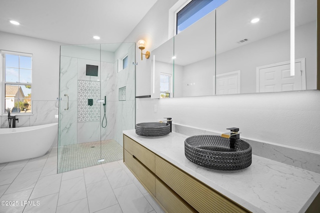 bathroom with tile patterned floors, independent shower and bath, and vanity