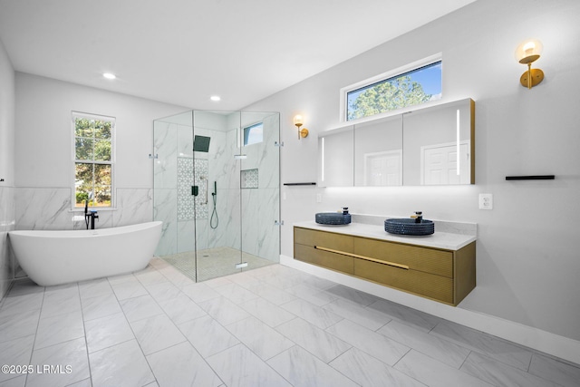 bathroom with vanity and independent shower and bath