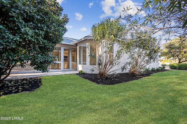 view of front of property featuring a sunroom and a front yard