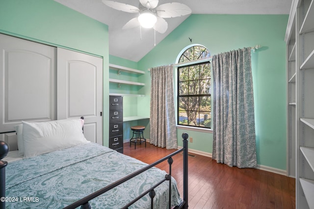 bedroom featuring ceiling fan, dark hardwood / wood-style floors, vaulted ceiling, and a closet