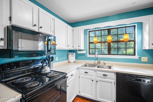 kitchen featuring white cabinetry, sink, black appliances, and a textured ceiling