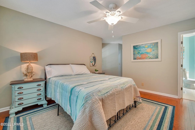 bedroom with ceiling fan, wood-type flooring, and ensuite bath