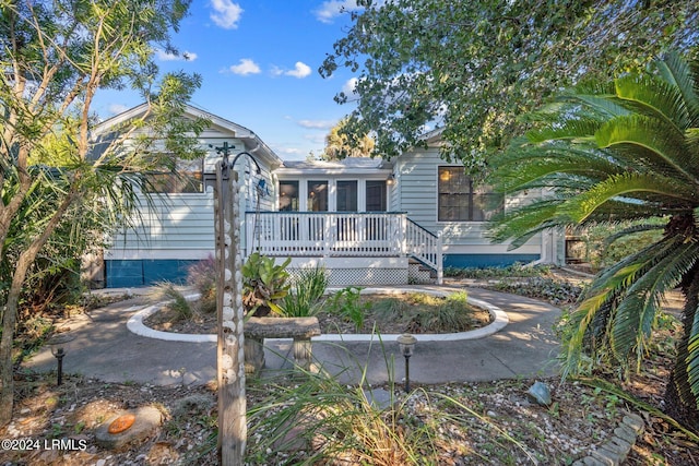 rear view of house with a wooden deck