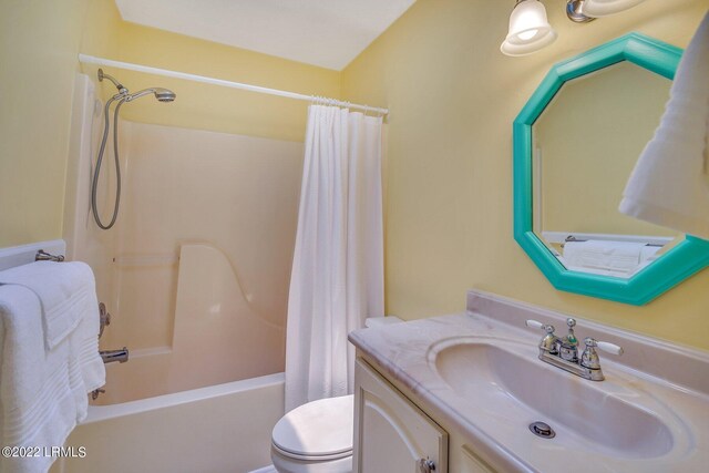 full bathroom with vanity, shower / tub combo with curtain, and toilet