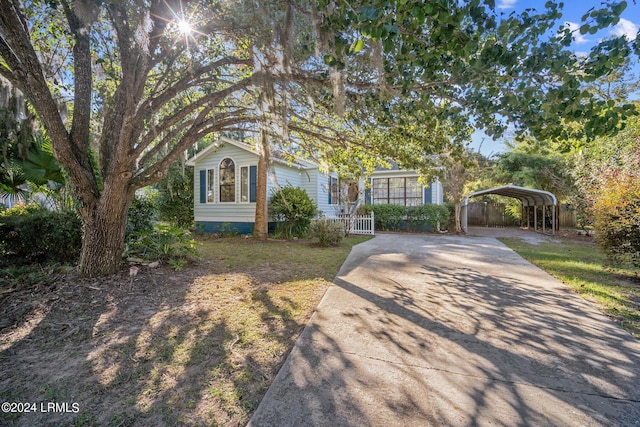 view of property hidden behind natural elements with a carport