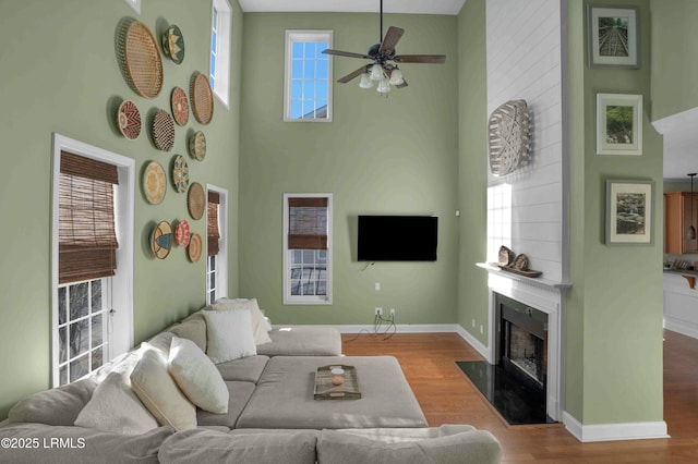 2176 Blakers Blvd, Okatie, SC 29909 - living room with a high ceiling, a fireplace, baseboards, and wood finished floors