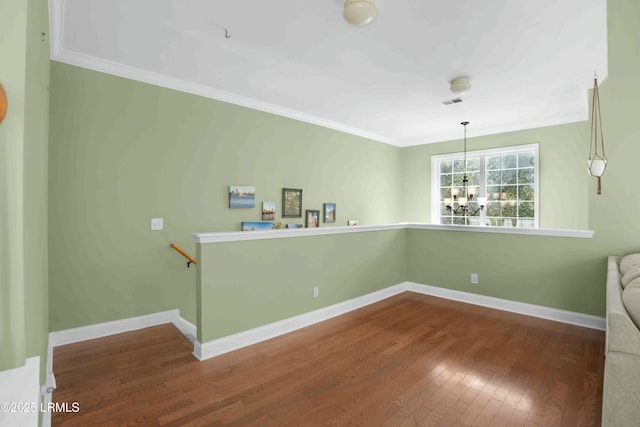 2176 Blakers Blvd, Okatie, SC 29909 - spare room with a notable chandelier, wood-type flooring, visible vents, ornamental molding, and baseboards