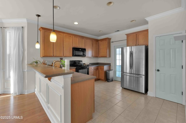 2176 Blakers Blvd, Okatie, SC 29909 - kitchen featuring a peninsula, black appliances, brown cabinetry, and crown molding