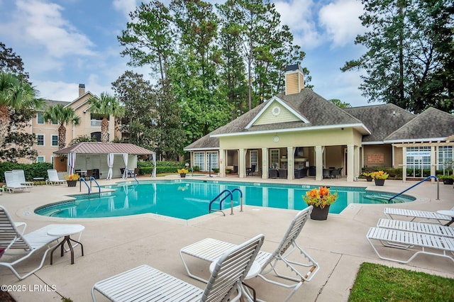 380 Marshland Rd Unit E26, Hilton Head Island, SC 29926 - community pool featuring a patio area, a storage structure, and an outbuilding