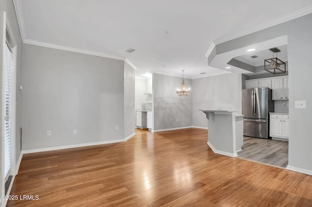 380 Marshland Rd Unit E26, Hilton Head Island, SC 29926 - unfurnished living room featuring a chandelier, crown molding, and light wood finished floors
