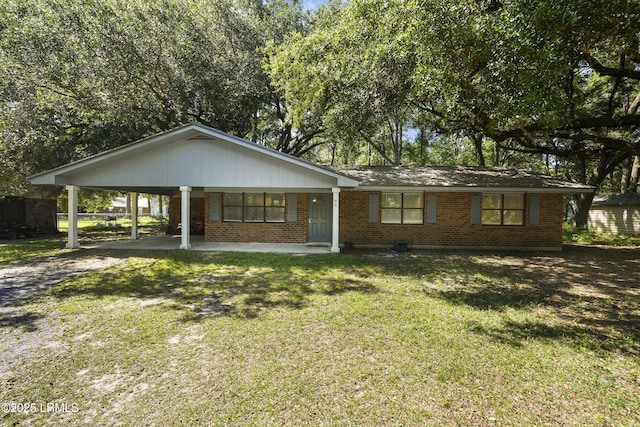 96 Pine Forest Loop, Ridgeland, SC 29936 - view of front of property with driveway, brick siding, a front yard, and a carport
