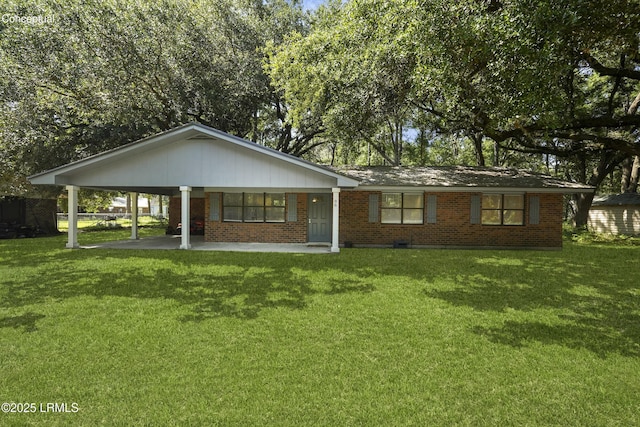 96 Pine Forest Loop, Ridgeland, SC 29936 - view of front of house with a front lawn, brick siding, and a carport
