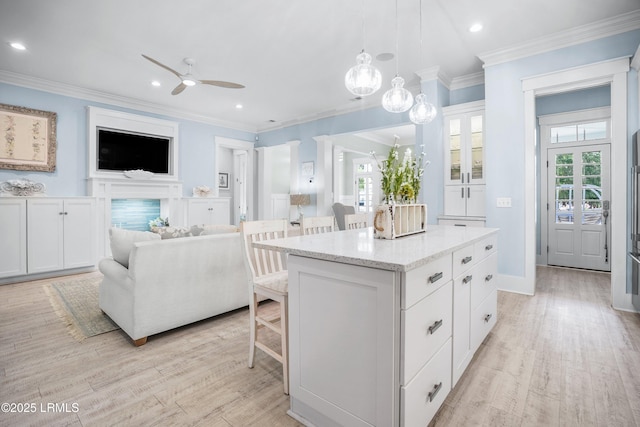 3 Veridian Park E, Beaufort, SC 29907 - kitchen with a kitchen breakfast bar, white cabinetry, a kitchen island, healthy amount of natural light, and ornamental molding