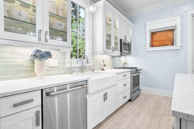 3 Veridian Park E, Beaufort, SC 29907 - kitchen featuring appliances with stainless steel finishes, ornamental molding, tasteful backsplash, light stone counters, and plenty of natural light