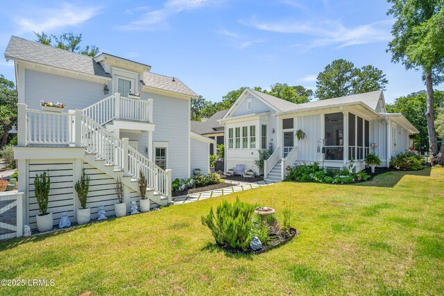 3 Veridian Park E, Beaufort, SC 29907 - view of front of home featuring stairs, a front yard, a shingled roof, a sunroom, and board and batten siding
