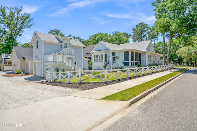 3 Veridian Park E, Beaufort, SC 29907 - view of front of home featuring board and batten siding, driveway, a fenced front yard, an attached garage, and stairway