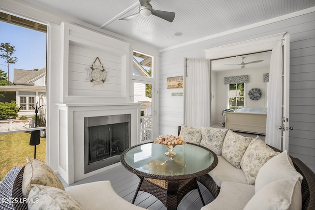 3 Veridian Park E, Beaufort, SC 29907 - living area featuring a ceiling fan, a fireplace, and wood walls
