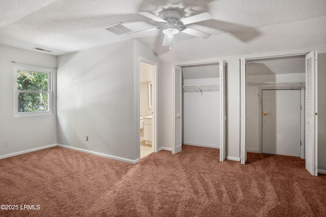 900 Brotherhood Rd Unit J6, Beaufort, SC 29902 - unfurnished bedroom featuring baseboards, two closets, a textured ceiling, and carpet