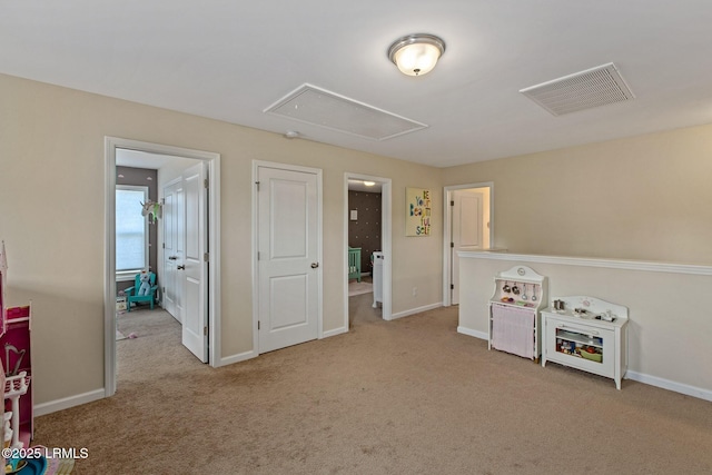 rec room with baseboards, carpet floors, visible vents, and attic access