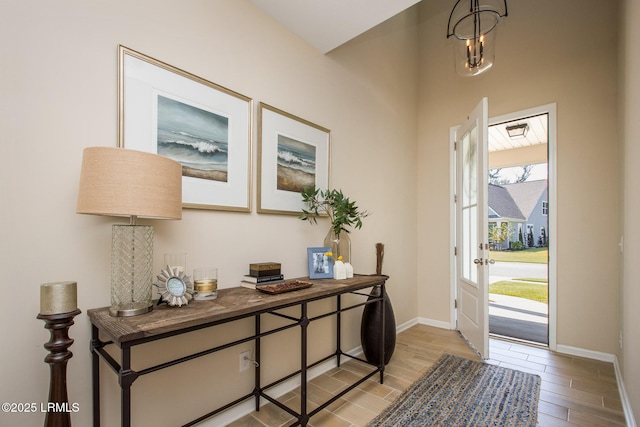 foyer entrance featuring light wood-style floors and baseboards