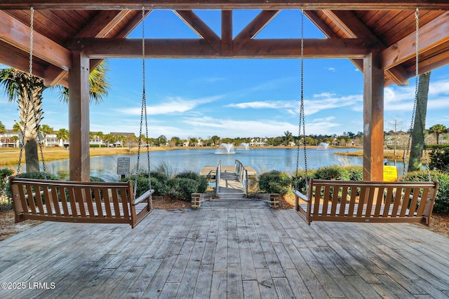 wooden deck featuring a water view