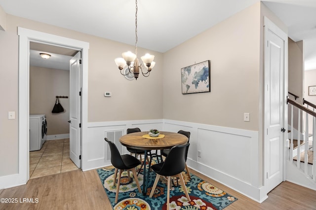 35 Sommer Lake Dr, Beaufort, SC 29902 - dining area featuring independent washer and dryer, visible vents, light wood-type flooring, a wainscoted wall, and stairs