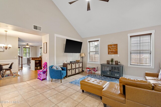 35 Sommer Lake Dr, Beaufort, SC 29902 - living room with visible vents, baseboards, high vaulted ceiling, ceiling fan with notable chandelier, and light tile patterned floors