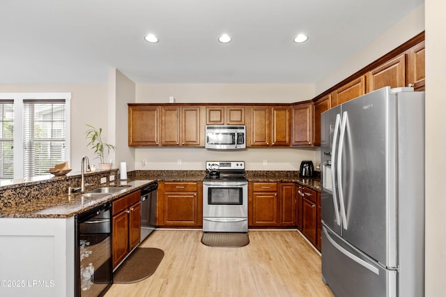 35 Sommer Lake Dr, Beaufort, SC 29902 - kitchen with appliances with stainless steel finishes, a sink, a peninsula, light wood-style floors, and recessed lighting