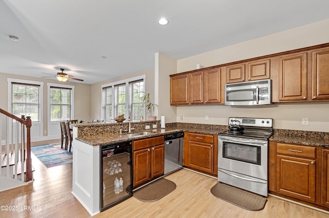 35 Sommer Lake Dr, Beaufort, SC 29902 - kitchen featuring wine cooler, stainless steel appliances, brown cabinets, and light wood-style flooring
