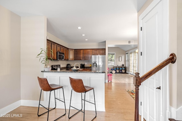 35 Sommer Lake Dr, Beaufort, SC 29902 - kitchen with appliances with stainless steel finishes, a breakfast bar, recessed lighting, a peninsula, and visible vents