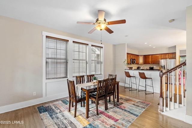 35 Sommer Lake Dr, Beaufort, SC 29902 - dining space with light wood-style floors, a ceiling fan, baseboards, and stairway