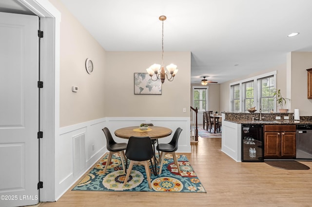 35 Sommer Lake Dr, Beaufort, SC 29902 - dining space with visible vents, wainscoting, wine cooler, light wood-style flooring, and ceiling fan with notable chandelier