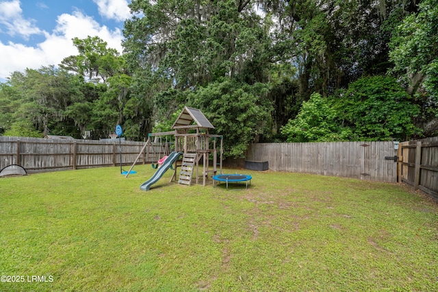 35 Sommer Lake Dr, Beaufort, SC 29902 - view of yard with a playground, a trampoline, and a fenced backyard