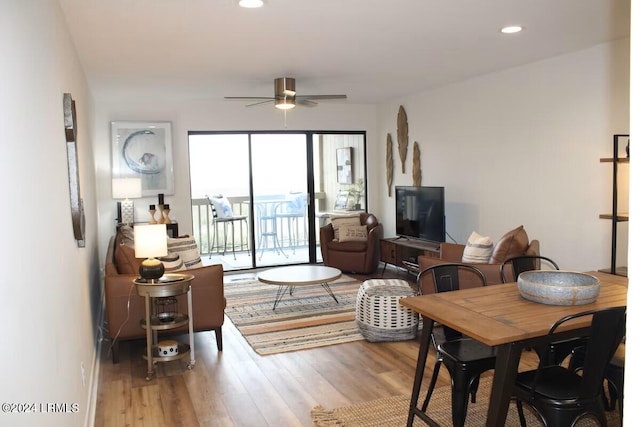 living room with hardwood / wood-style flooring and ceiling fan