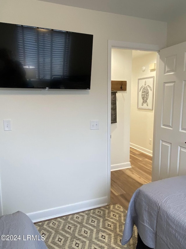 bedroom with wood-type flooring