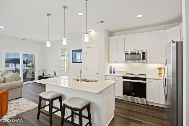 69 Garden Gate Ln, Hardeeville, SC 29927 - kitchen with appliances with stainless steel finishes, a sink, open floor plan, decorative backsplash, and white cabinets