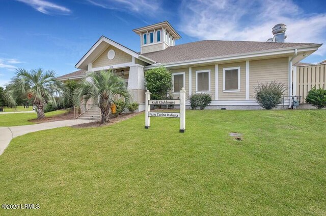 69 Garden Gate Ln, Hardeeville, SC 29927 - view of front of property featuring a front yard, driveway, covered porch, and a shingled roof