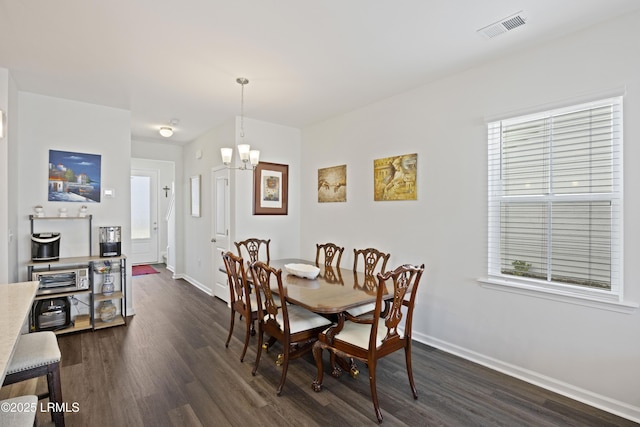 69 Garden Gate Ln, Hardeeville, SC 29927 - dining room featuring dark wood-style flooring, a chandelier, baseboards, and healthy amount of natural light