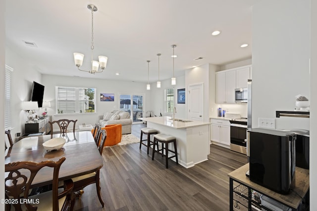 69 Garden Gate Ln, Hardeeville, SC 29927 - dining area featuring dark wood finished floors, a chandelier, and recessed lighting
