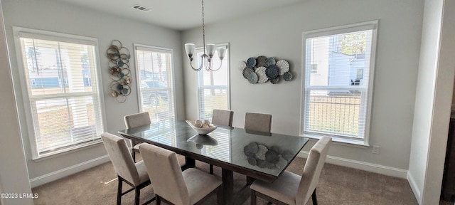1272 Windswept Oak Ln, Beaufort, SC 29902 - carpeted dining area featuring a wealth of natural light and an inviting chandelier