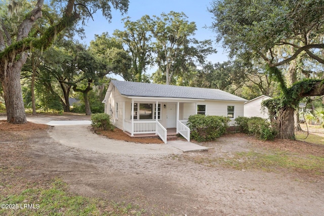 view of front of home featuring a porch and a shingled roof