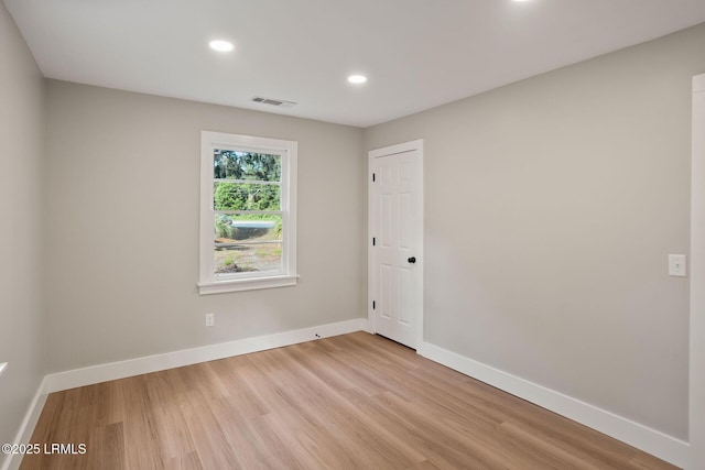 spare room featuring recessed lighting, visible vents, light wood finished floors, and baseboards