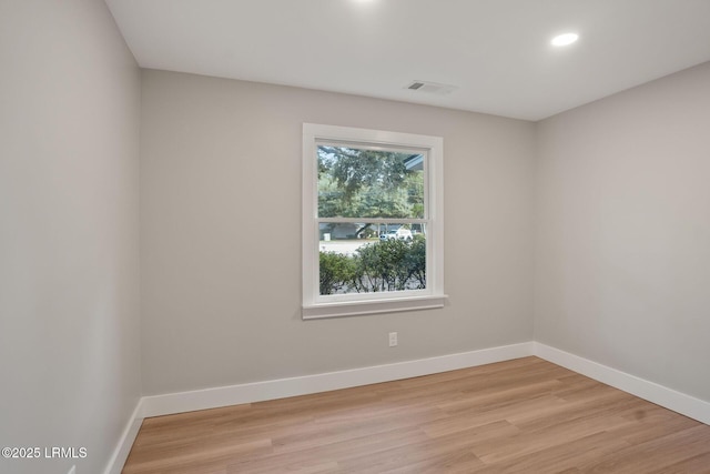 spare room with recessed lighting, light wood-style flooring, and baseboards