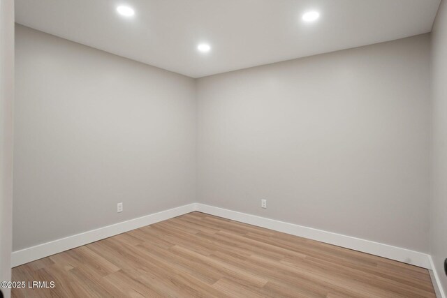 unfurnished room with light wood finished floors, baseboards, and recessed lighting
