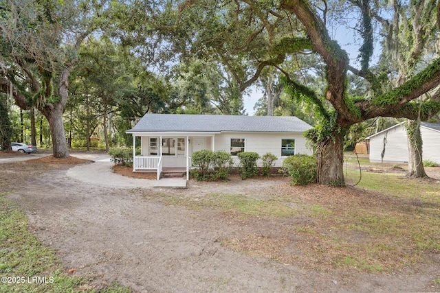 view of front of home featuring a porch and a shingled roof