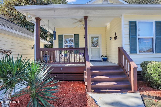 entrance to property with ceiling fan and a porch